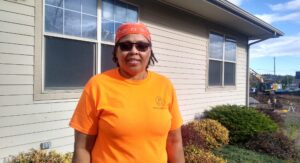 Karen Jones stands in front of her house